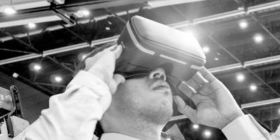 A man in a white shirt using a virtual reality device for skilled trades training