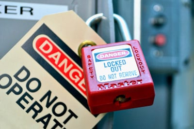 A red padlock with a "Don't Operate" sign attached to it.