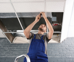 Men doing facliitoes maintenance on a ceiling that has undergone skilled trades workforce development