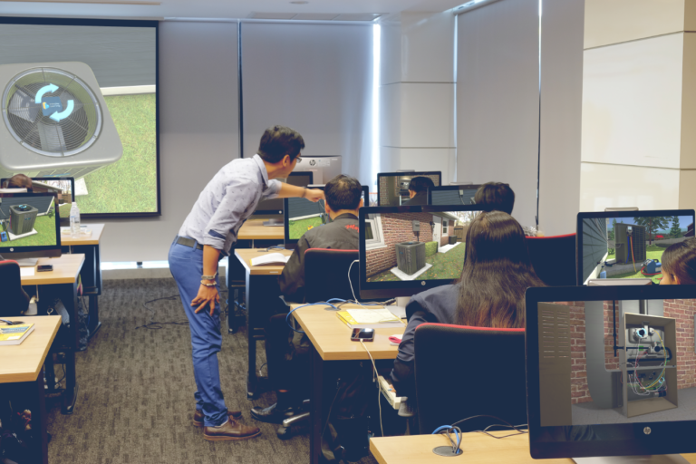 A technical college classroom full of students engaged in immersive learning with 3D simulations
