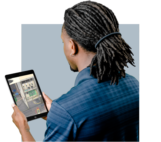 A man with dreadlocks using a tablet for online commercial hvac training