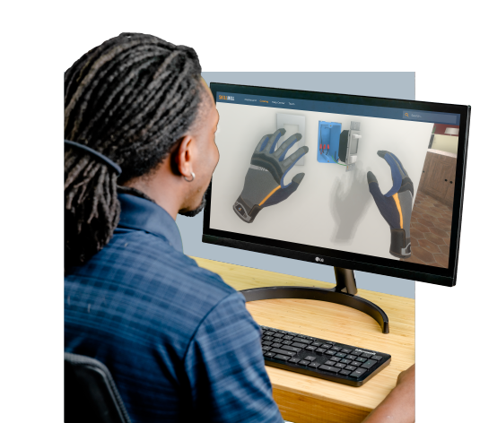 A man sitting at a desk in front of a computer doing online electrical training