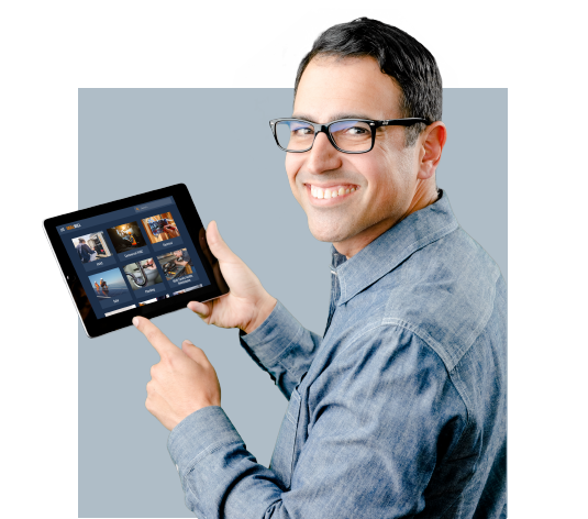 A man wearign glasses holding a tablet and using it for solar technician training