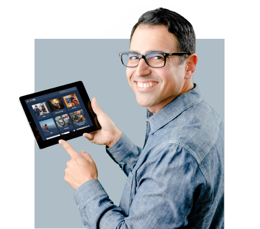 A man wearign glasses holding a tablet and using it for solar technician training