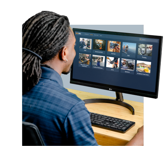 A man with dreadlocks using a computer for online multi-family maintenance training