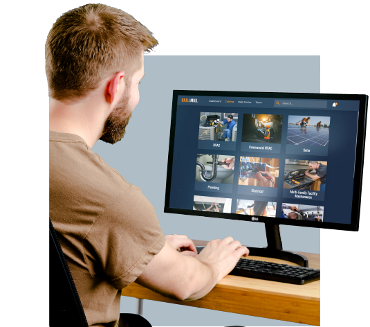 A man sitting infront of a computer monitor using it for online solar training