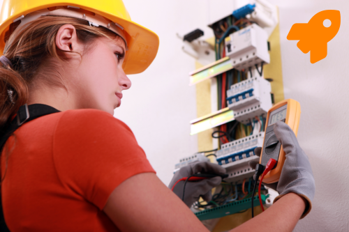 A woman in a hard hat who is doing electrical maintenance & troubleshooting