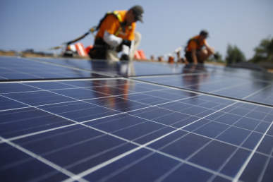 Men installing solar panels that have undergone skilled trades workforce development