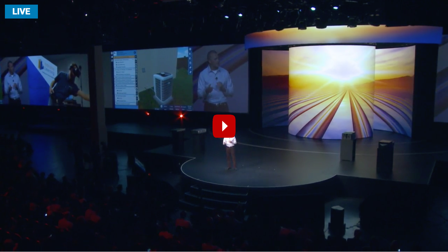 A man on a stage giving a presentation