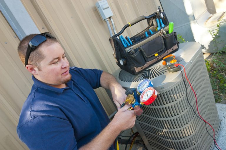 A man working on an air conditioner