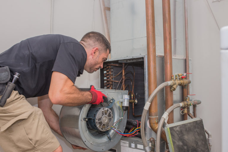 A man working on a hot water heater