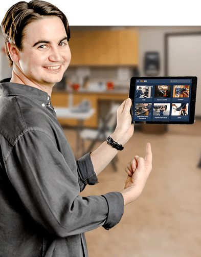 A man holding and point to a tablet displaying online safety training from Interplay