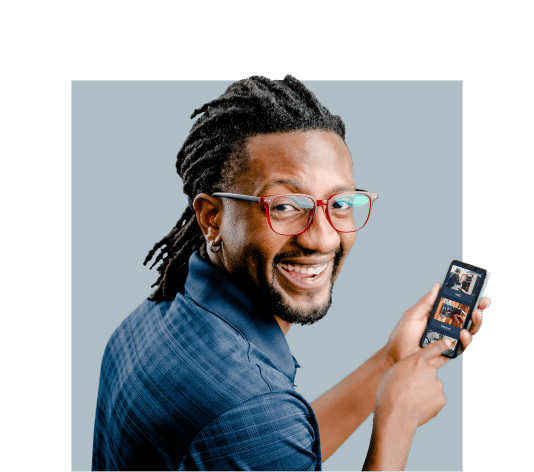 A man with dreadlocks holding a cell phone