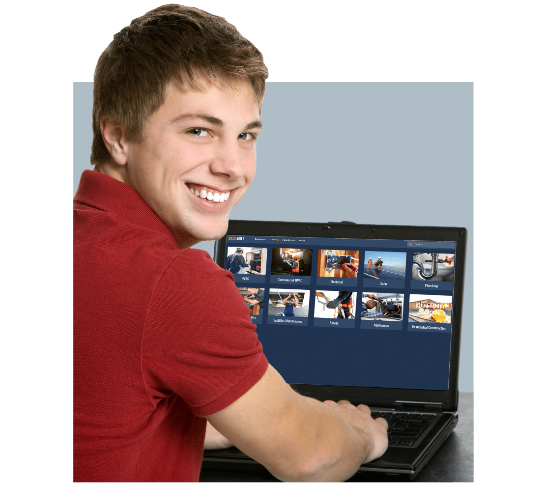 A smiling male k-12 student using a laptop for skilled trades training
