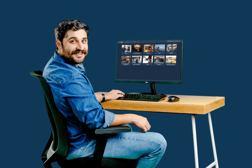 A man sittting a desk using a computer taking skilled trades training courses