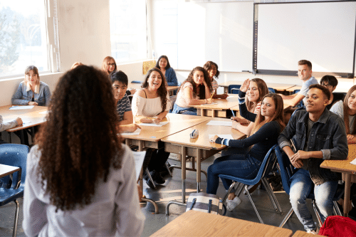 A teacher connecting with a group of students in a Gen Z classroom