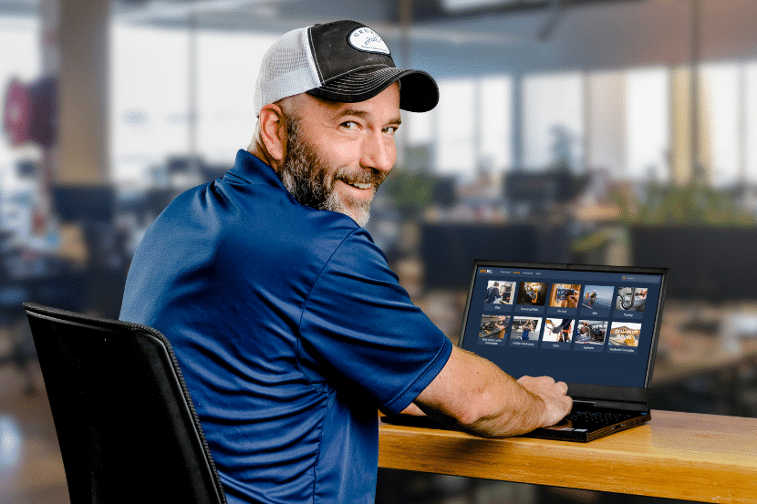 A Man Sitting at a Computer With Interplay Learning's Career Development Platform