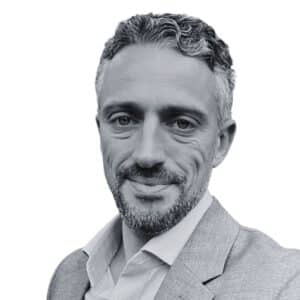 a black and white photo of a man in a suit