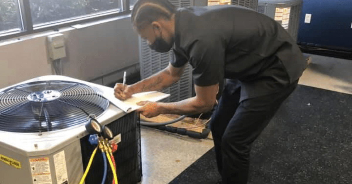 a man working on an air conditioner in a room