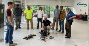 a group of men standing around a bunch of tools