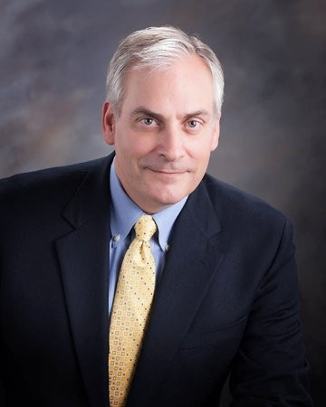 a man in a suit and tie posing for a picture