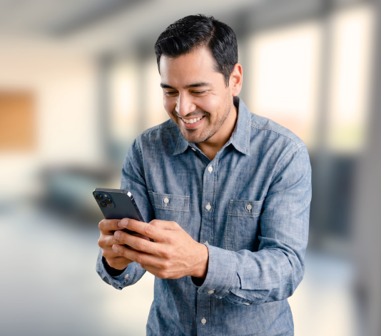 A man wearing a grey shirt engaging with the SkillMill mobile application for skilled trades training
